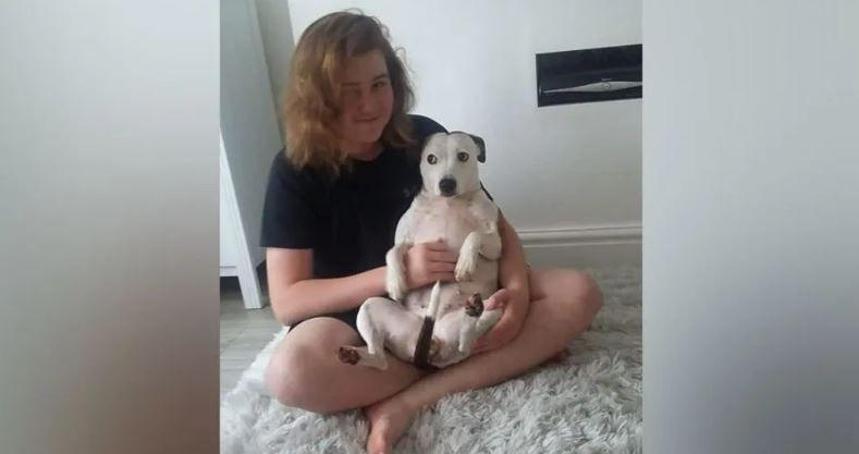 Ellis Cox smiling with his dog 