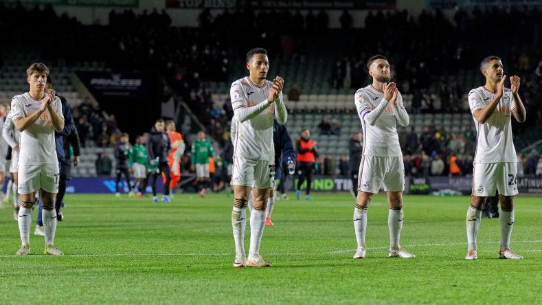 Swansea's players clap the away fans after victory at Plymouth