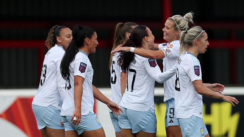 Aston Villa players celebrate their first goal