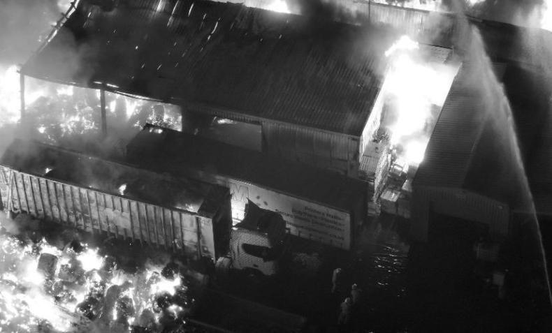 Flames can be seen engulfing a building in an aerial picture of a recycling centre.