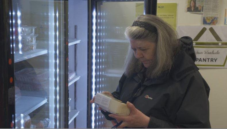 woman reading food label