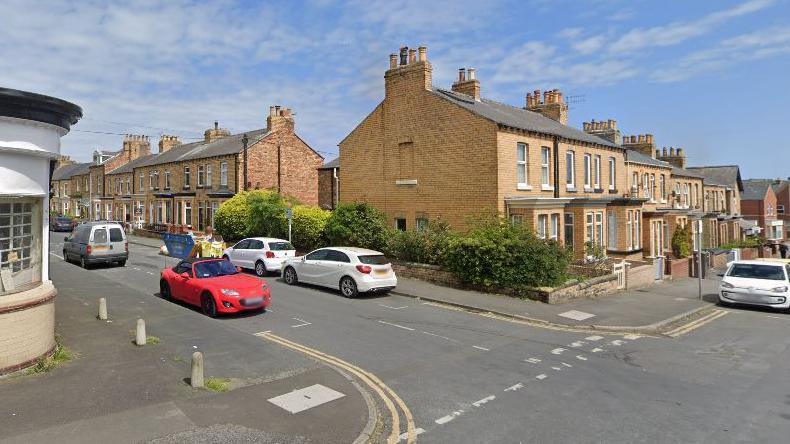 Garfield Road, near to the Junction with Franklin Street. The street is a residential one with cars parked on either side of the road.