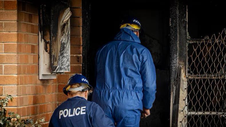 Police make their way into the house in western Sydney