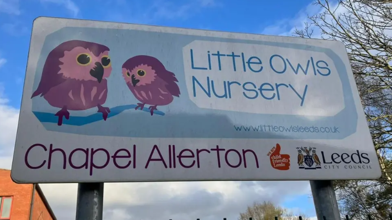 A Little Owls Nursery sign. Two cartoon owls are illustrated alongside the title, with 'Chapel Allerton' written underneath. A Leeds City Council logo can be seen on the far left, at the bottom of the sign.