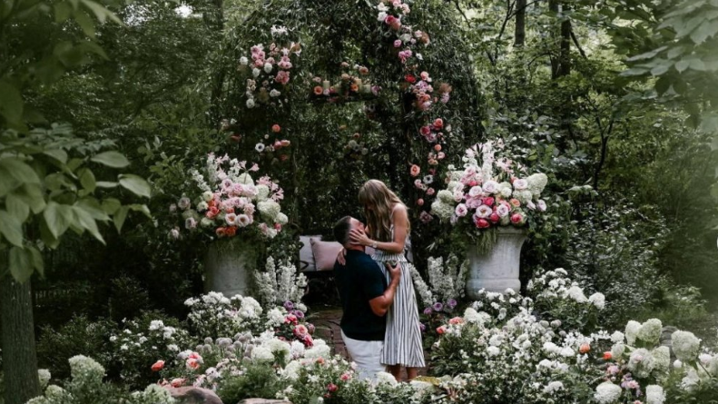 Travis Kelce gets on one knee to pop the question to Taylor Swift surrounded by an abundance of flowers.