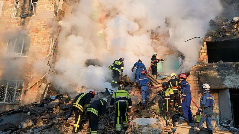 Firefighters search the rubble of a destroyed building in Kyiv