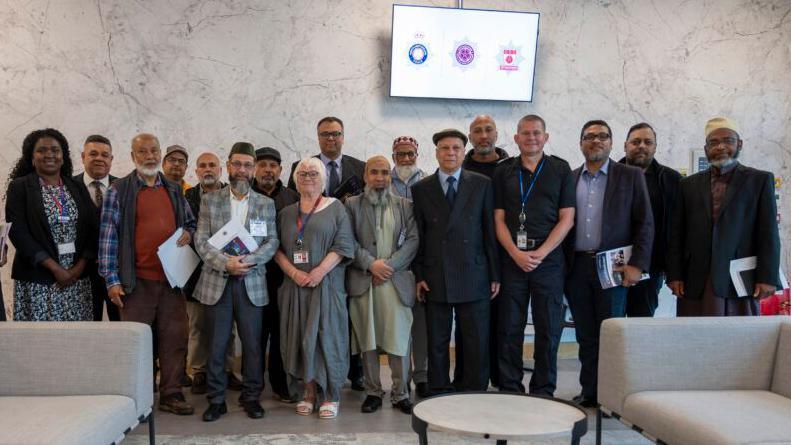 A group of people including both men and woman. Some are Muslim leaders while the others include the PFCC, the Deputy Commissioner Marianne Kimani, and the Chief Constable.