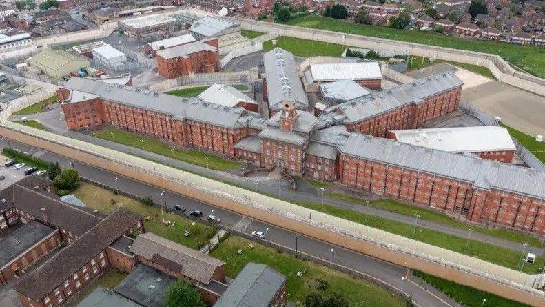 Wakefield Prison, pictured from above. A series of Victorian era buildings run alongside one another.