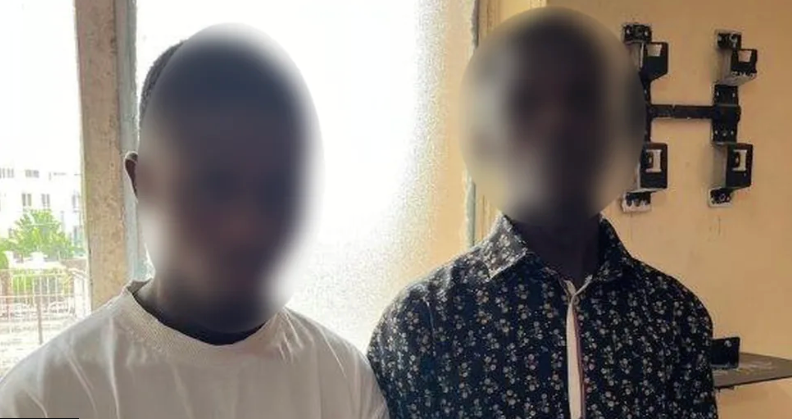 Two blurred Nigerian men