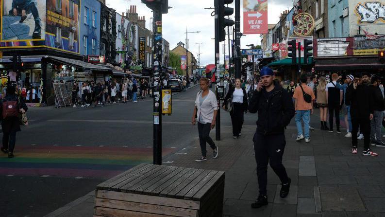 Image from 2022 showing people crossing a road in the Camden High Street area