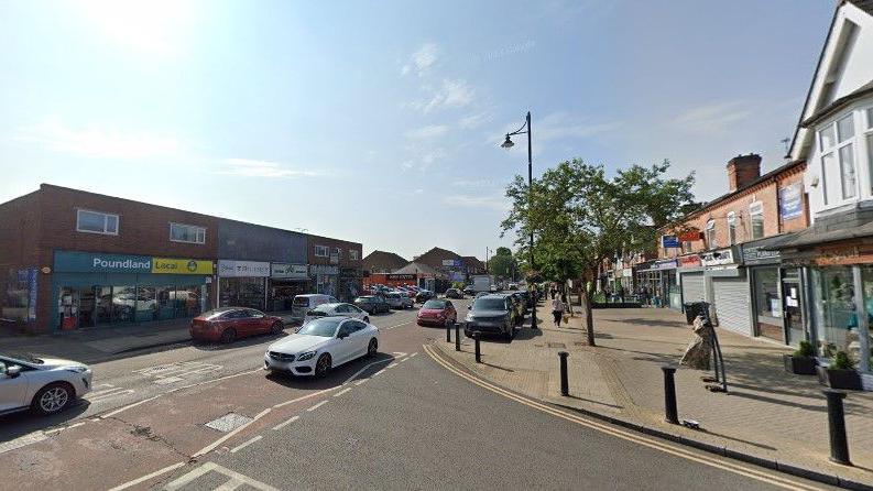 A road junction with lots of shops lining the streets