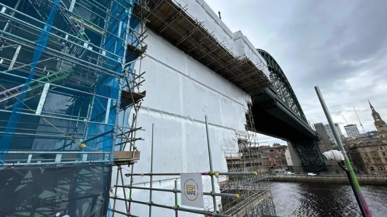 Scaffolding covering one of the stone towers and part of the Tyne Bridge.