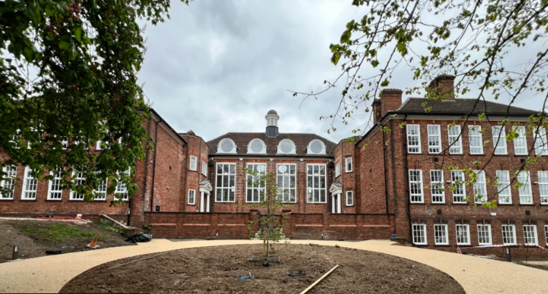 Large victorian building orange bricks large rectangular white framed windows
