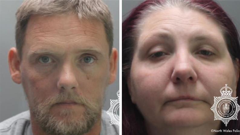 A composite picture of Michael and Kerry Ives' police mugshots. Michael Ives wear a grey top. They are both looking at the camera. The North Wales Police logo is in the bottom right of both pics.