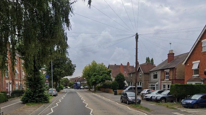 An image of North Parade, a residential street with houses and footpaths, it is lined with trees.