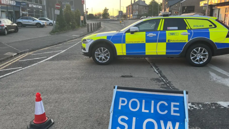 A police car is parked on a cordoned-off stretch of road at Clarkston Toll