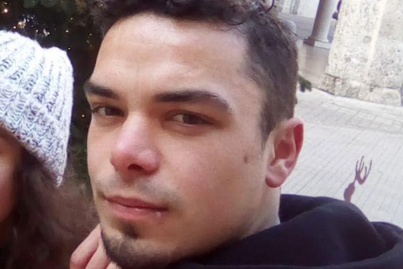 Close-up of Leonard Farruku looking at the camera. He has smartly cropped dark hair and a stubble goatee beard and has a serious expression.