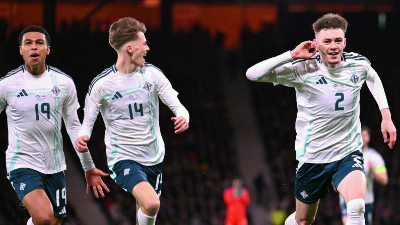 Conor Bradly, Isaac Price and Shea Charles celebrate a goal against Scotland