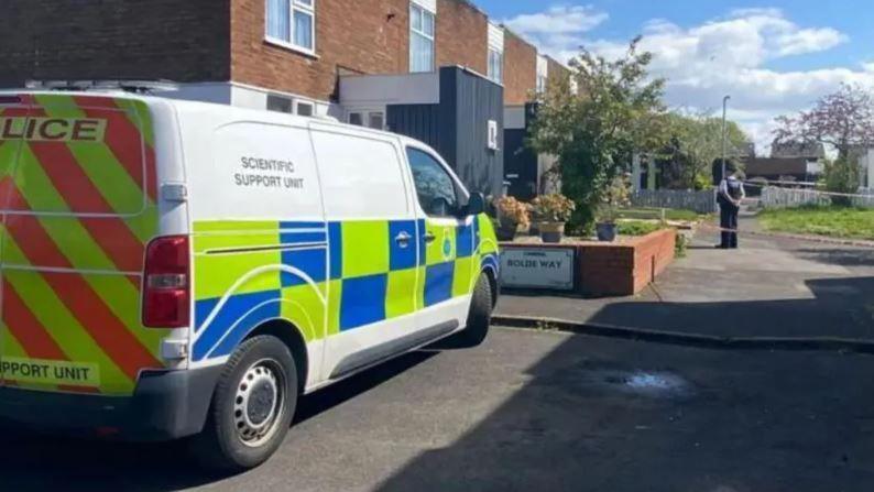 Police van outside house which is cordoned off by police tape