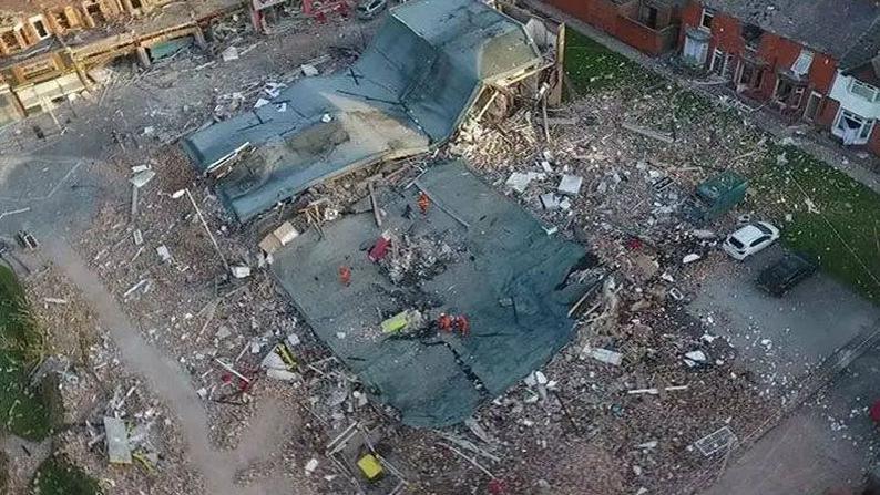 An aerial view of the site of the New Ferry gas explosion showing a building completely destroyed and bricks piled everywhere