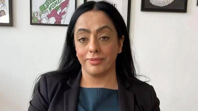 Councillor Arooj Shah looks at the camera, smiling, wearing a black blazer and a blue blouse. She has long dark hair and brown eyes.