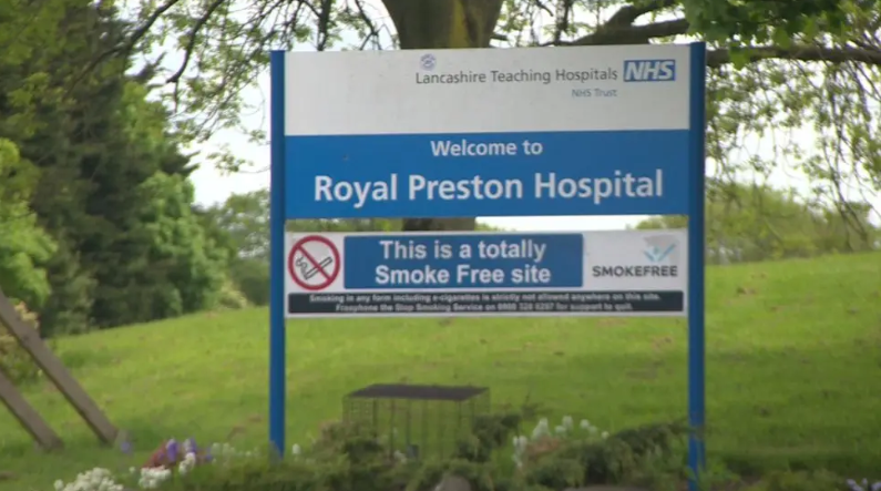 A sign in a grassy area outside the Royal Preston Hospital