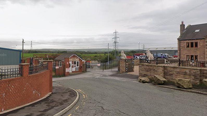 A commercial site on Meadow Street, Great Harwood, showing green fields in the background.
