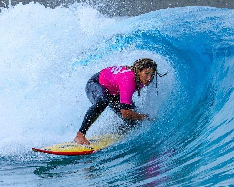 A young surfer rides a wave at The Wave man made surfing attraction near Bristol