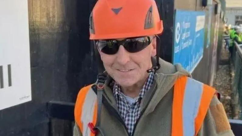 Glen Edwards wearing an orange hard hat, high-vis vest and sunglasses.