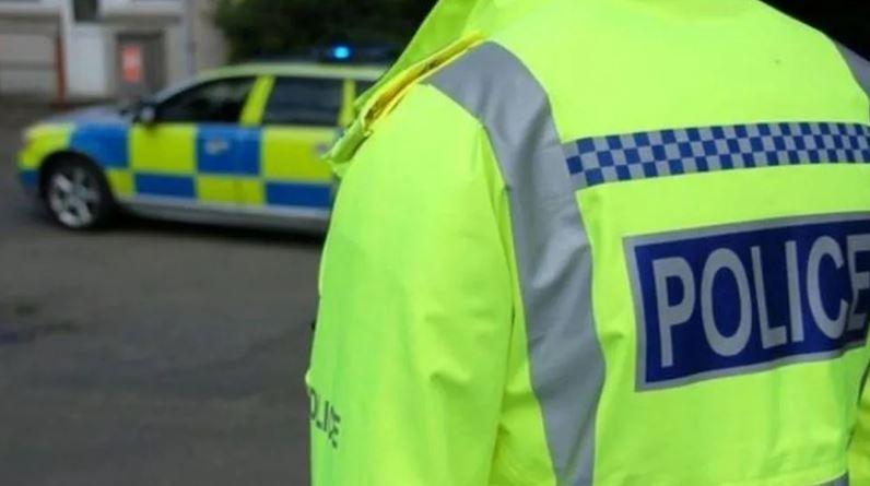 West Midlands Police officer and patrol car