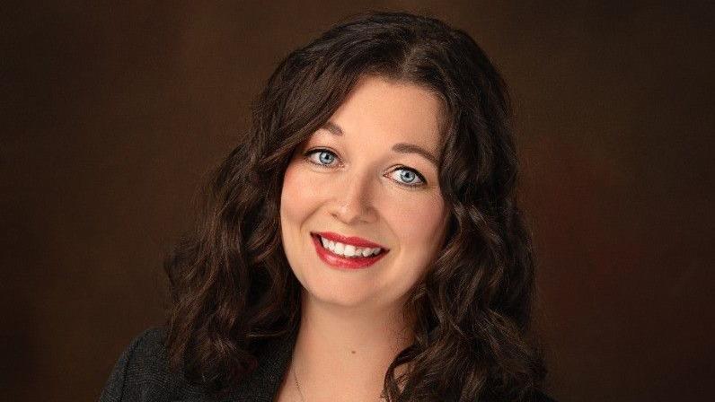 Crystal Morin smiles and looks into the camera.