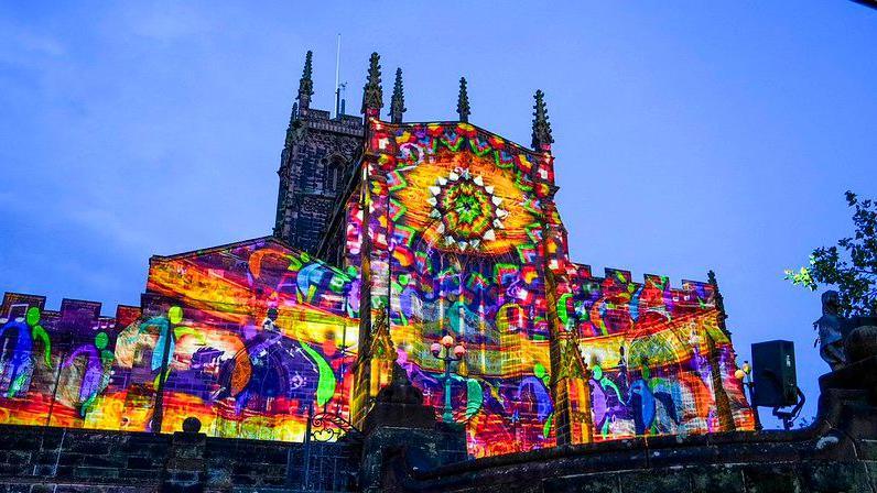 A Wolverhampton church illuminated with a multi-coloured light show.