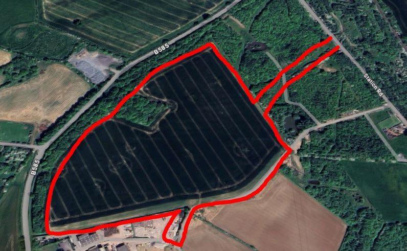 A red outline boundary on a map where the site would be. It forms a shovel shape across the map which has roads, fields and buildings in. 