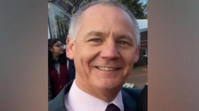 Paul Taylor, grey-haired and smiling, wearing a pink shirt, tie and jacket.