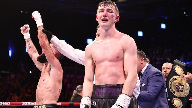 Colm Murphy disappointed as Jono Carroll has his hand raised in victory