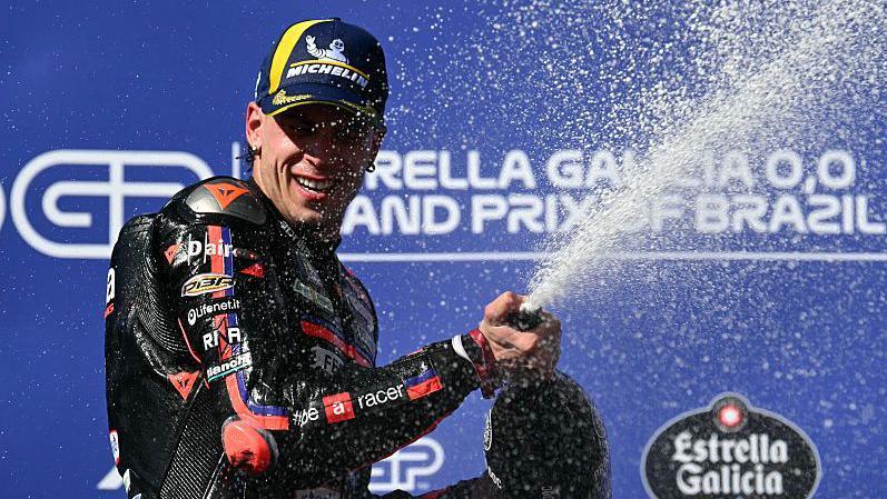 Italy's Marco Bezzecchi's sprays champagne on top of the podium after his victory in the MotoGP