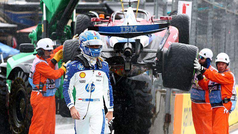 Charles Leclerc walks away from his crashed Ferrari at the Miami Grand Prix, as the car is lifted on to a truck