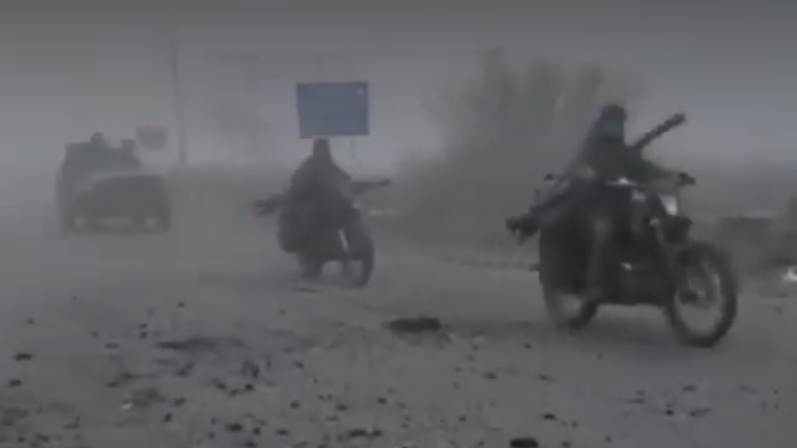 A foggy image of Russians on motor bike riding along a road in eastern Ukraine