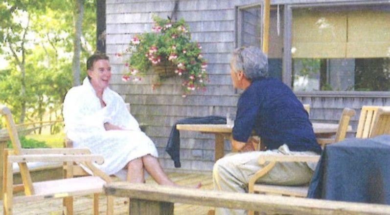 Peter Mandelson in a white dressing gown laughing with Epstein