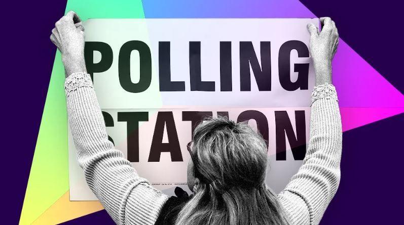 BBC promotional banner of woman sticking a polling station banner to the wall with colourful background