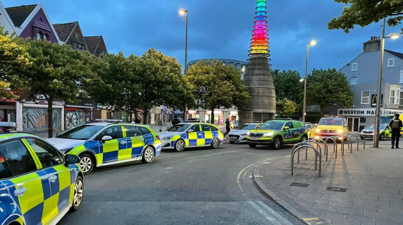 Police cars lining up along street at dusk in Weston-super-Mare