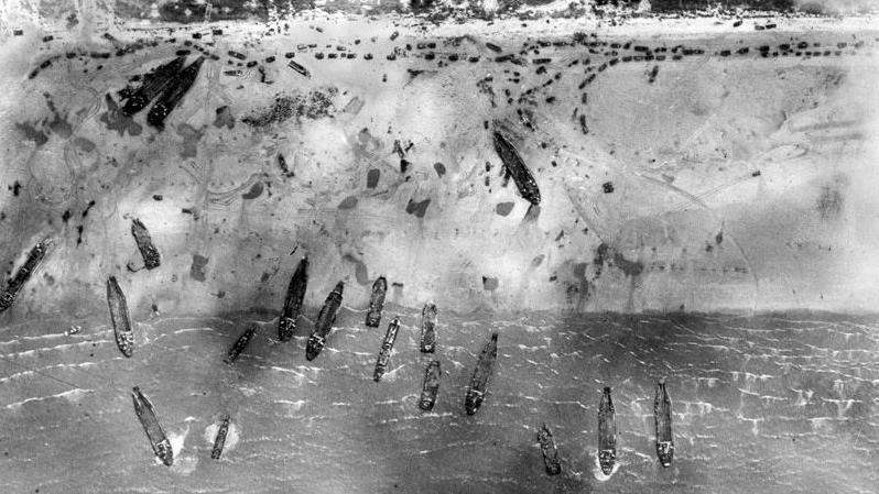 Archive image showing an aerial view of troops landing on D-Day at Sword beach