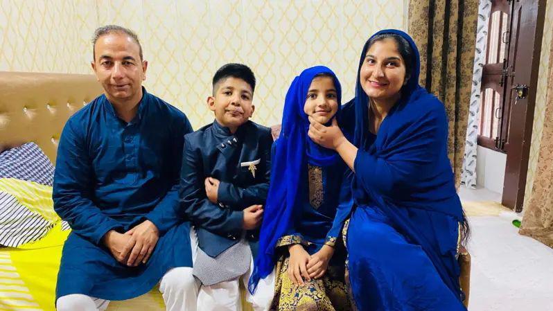 The twins seen sitting with their parents Urusa and Rameez Khan in a room.