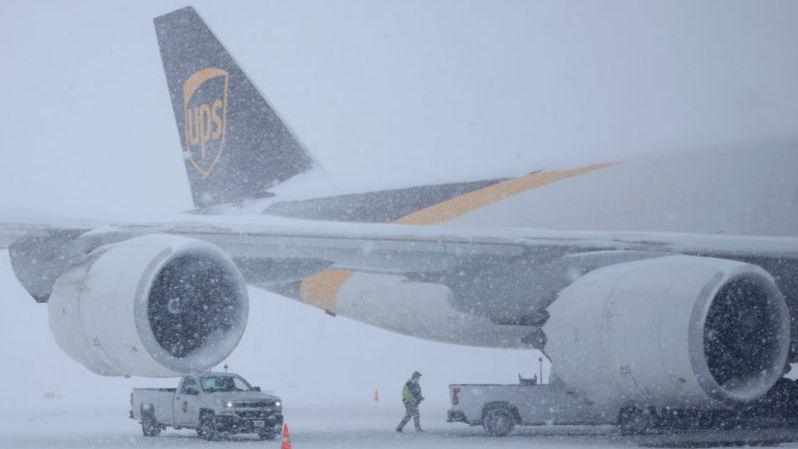 A UPS cargo jet sits parked in the snow at Louisville Muhammad Ali International Airport on 5 January 2025