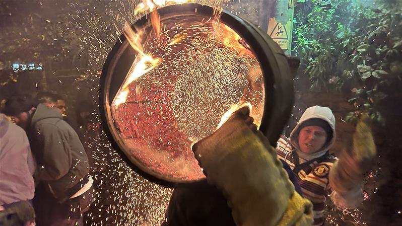 The inside of a flaming tar barrel as it is carried on someone's back.