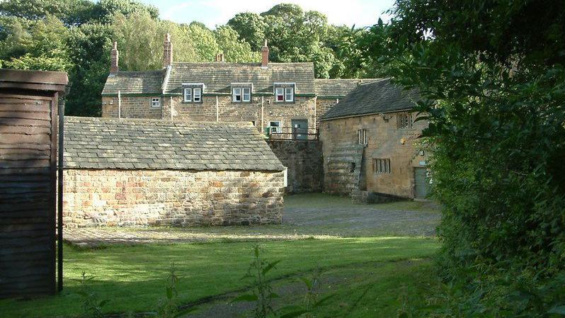 A view of the mill complex with the main mill building on the right. The oldest building is a two-storey watermill.