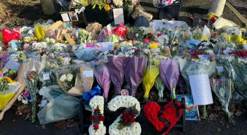 Floral tributes cover a large area at the scene of Leo's stabbing. There is a number twelve and a broken heart at the front, both made of flowers