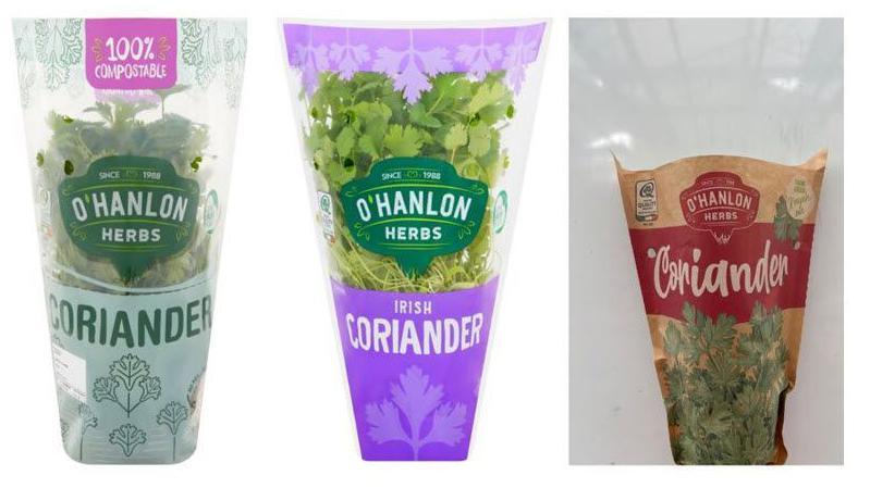 Three pots of coriander are wrapped in clear plastic and one in a brown wrapper.