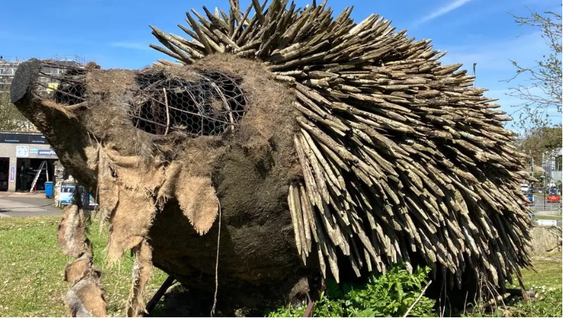 A ragged wooden hedgehog display after bird have taken material for their nests