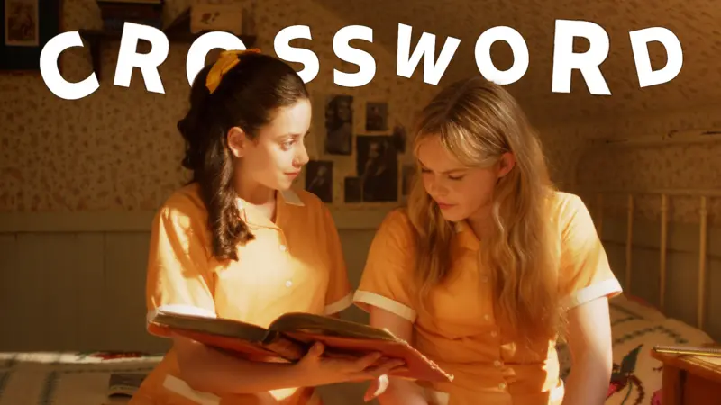 Girls dressed in Malory Towers school uniform reading a book sat down
